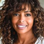 curly-layered-lob-with-wispy-bangs-haircut-on-smil