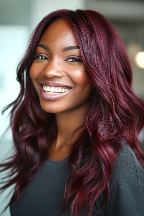 Dark cherry red waves on smiling beautiful black woman.