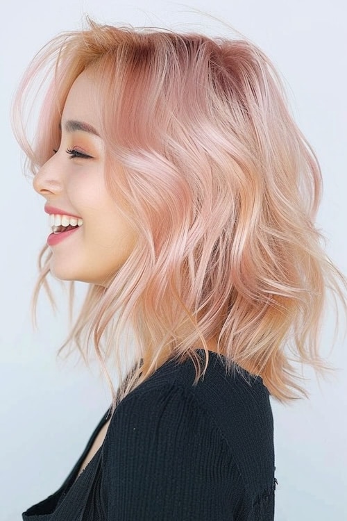 Light blond and pastel pink hair color. Side view.