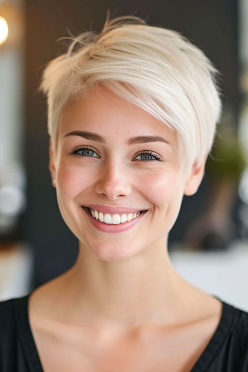 Platinum blond pixie on smiling young woman.