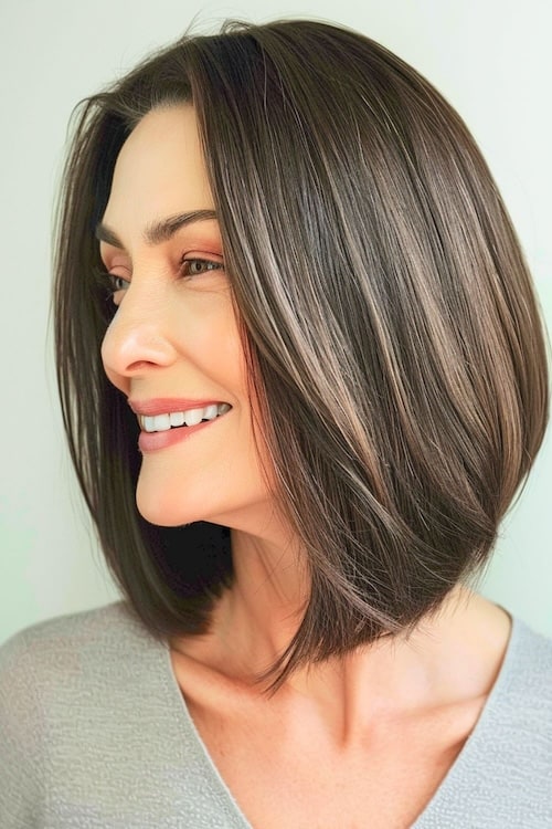 Sleek brown bob, side view, on older woman.