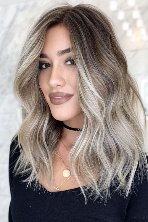 Ash blonde ombre on cocoa brown hair.