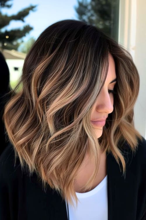 Blonde balayage highlights on dark brown shoulder-length hair.