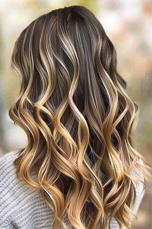 Dark brown hair with chunky blonde highlights.