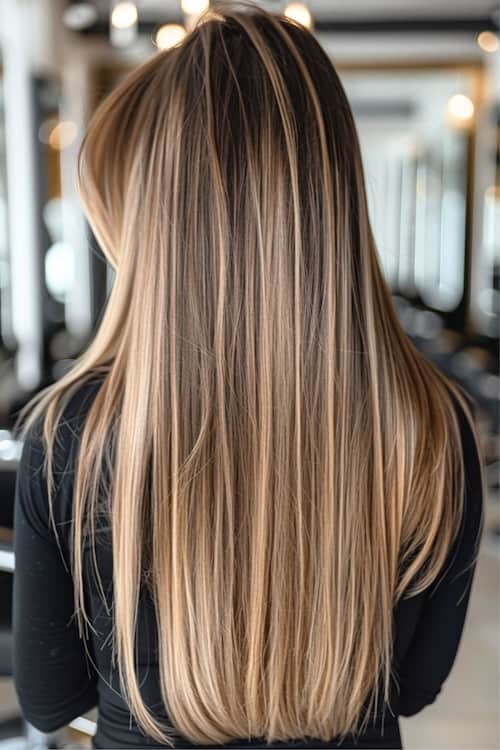 Dark brown long straight hair with butter blonde highlights.