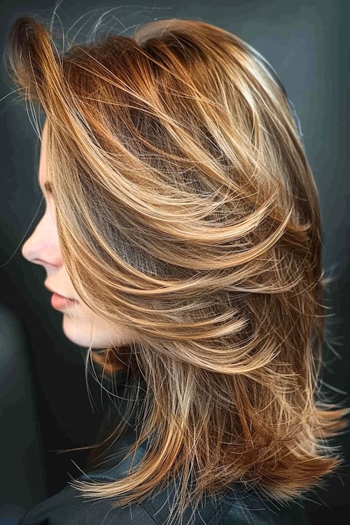 Feathered layered highlights on shoulder-length hair.