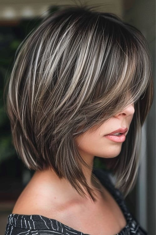 Platinum layered highlights medium-length haircut.