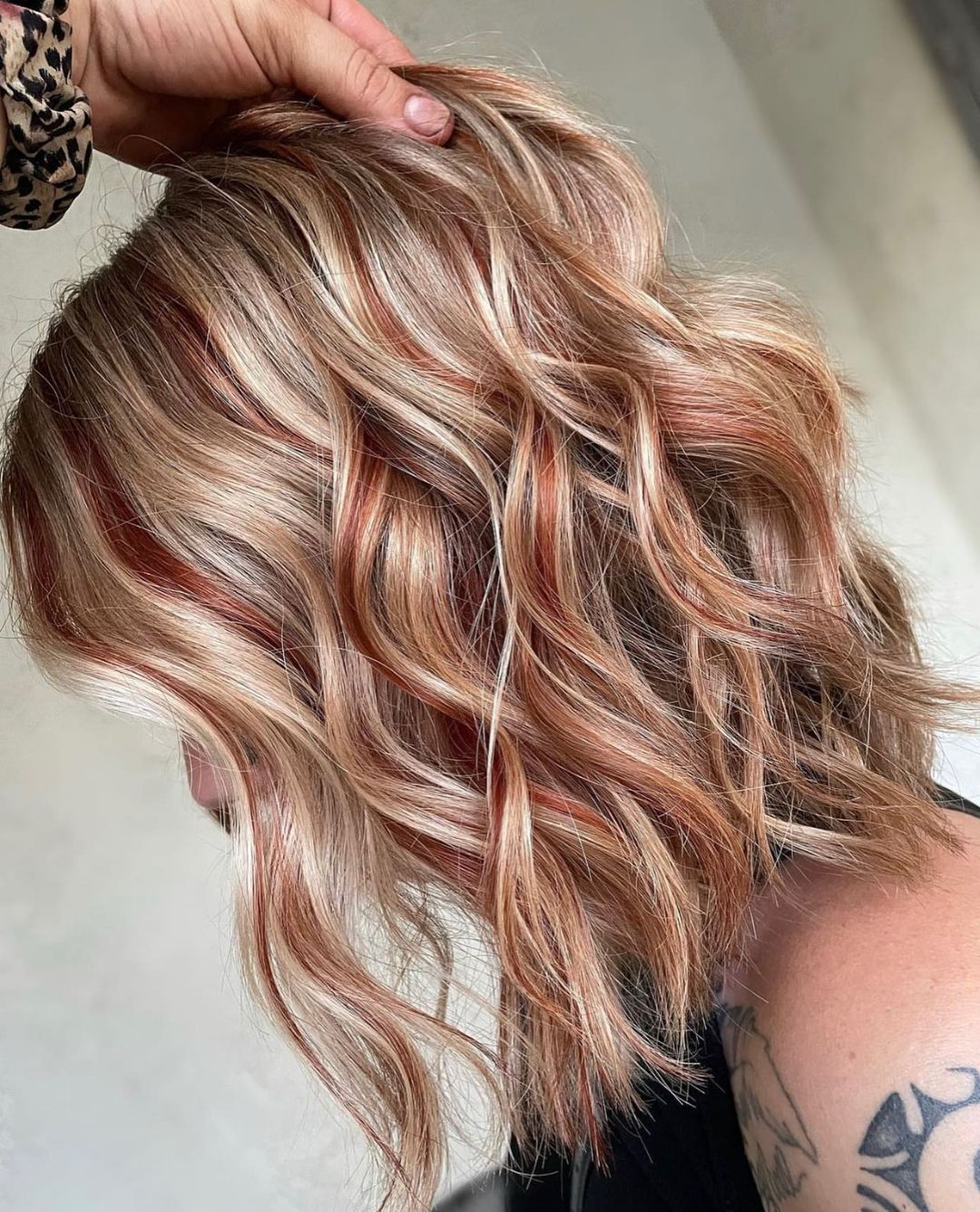 short wavy blonde hair with copper red lowlights