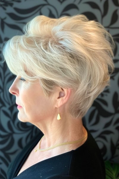 Voluminous blonde pixie for fine hair hairstyle for women in their 50s.