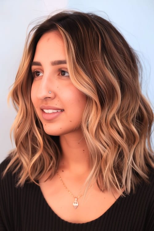 Wavy highlighted layers medium-length hair.