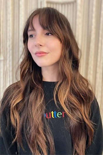 Long Tousled Waves With Piecey Bangs Hairstyle on a woman with long brown hair.