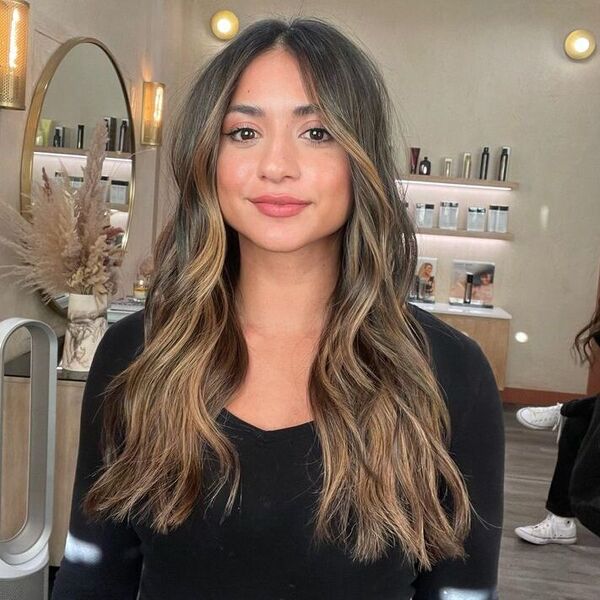 a woman inside a salon wearing a black longsleeve top