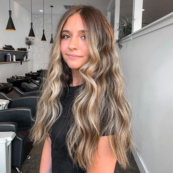 a woman inside a salon wearing a black top