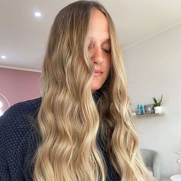 a woman inside a salon wearing a blue longsleeve