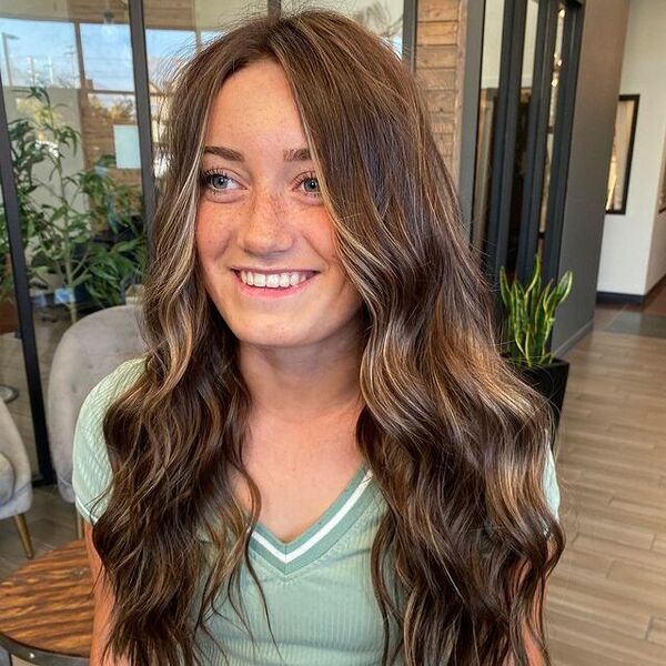 a woman inside a salon wearing a green shirt