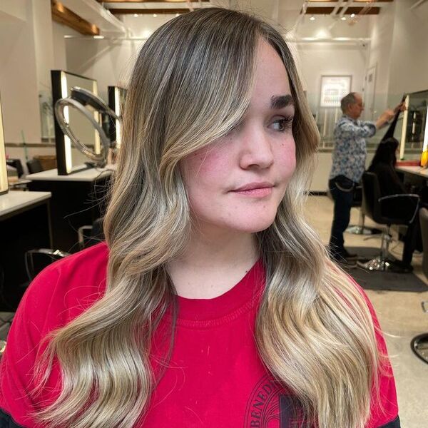 a woman inside a salon wearing a red printed shirt