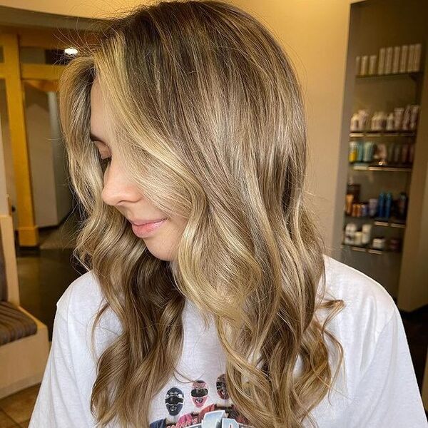 a woman inside a salon wearing a white printed shirt