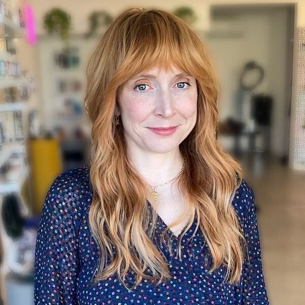 a woman wearing a blue longsleeve blouse