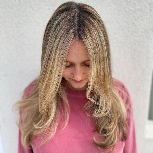 a woman with nose piercing wearing a pink longsleeve