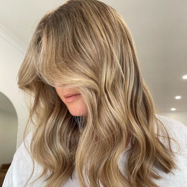 Baby Bronde Hair - a woman wearing a white blouse