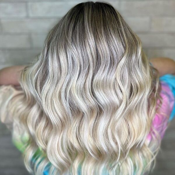 Baby Lights Platinum Blonde Balayage - a woman wearing a rainbow shirt