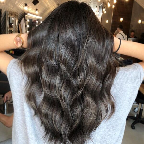 Beautiful Brunette Hair - a woman wearing gray top.