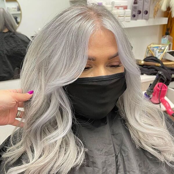 Blended Silver Platinum Hair - a woman wearing a black barber's cape and a facemask