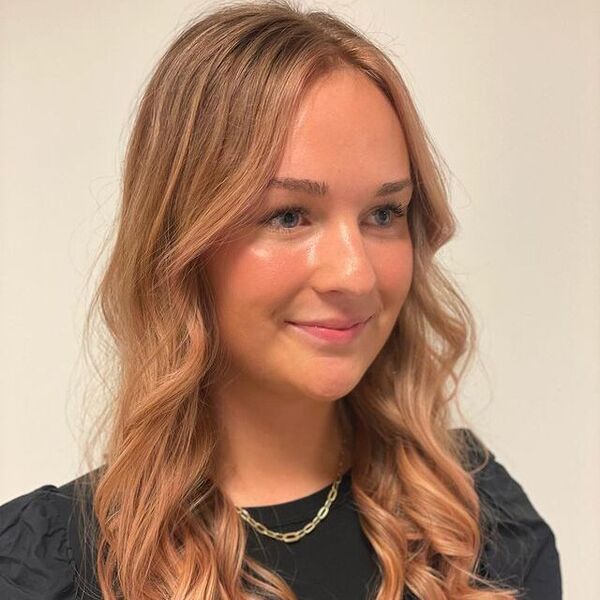 Bright Strawberry Blonde Hair - a woman wearing a black blouse