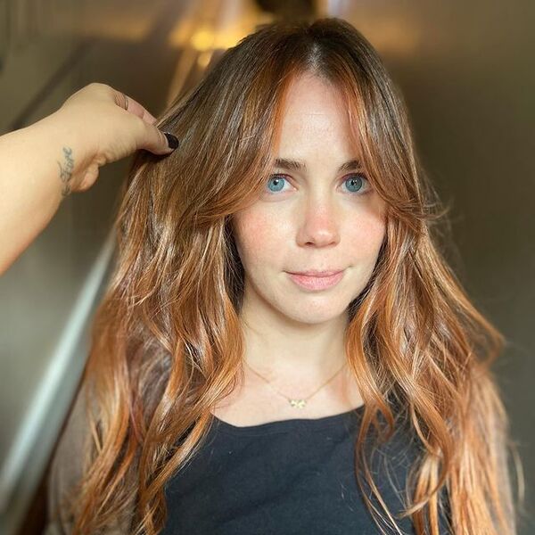 Face-Framing Strawberry Blonde Balayage - a woman wearing a necklace