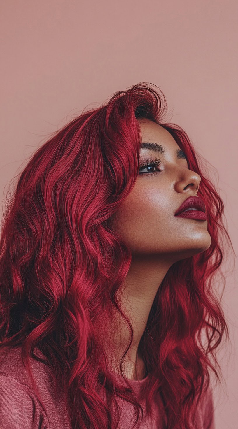 Fiery red wavy hair flowing down, worn by a woman with medium brown skin.