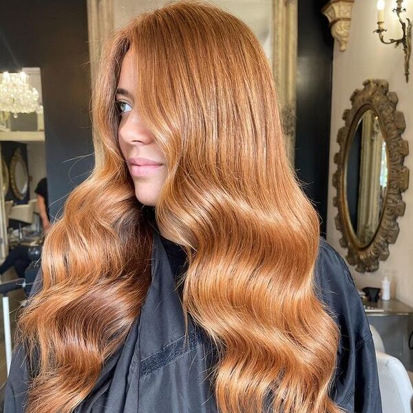 Long Strawberry Blonde Hair - a woman wearing a black cape