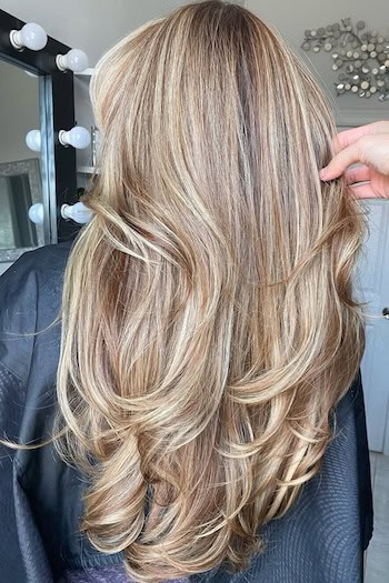 Long Warm Honey Blonde Layers on a woman with blonde hair, from back.