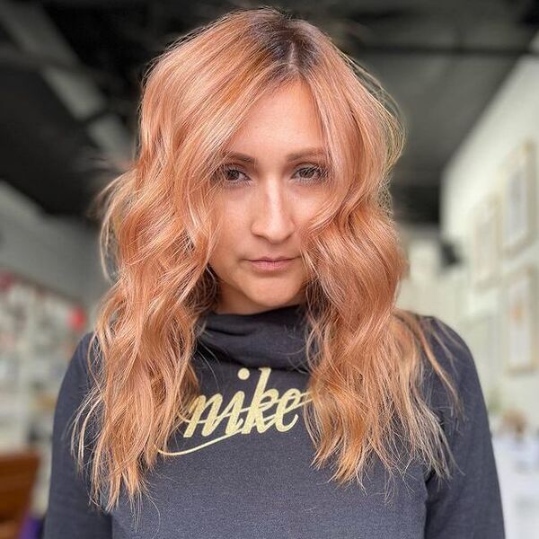 Messy Strawberry Blonde Hair - a woman wearing a gray jacket