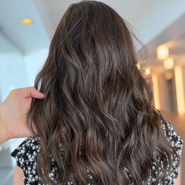 Messy Subtle Brunette - a woman wearing black floral blouse.