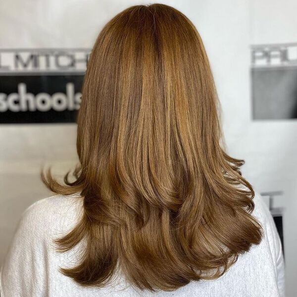 Over-All Layered Light Brown Hair - a woman wearing a white sweater