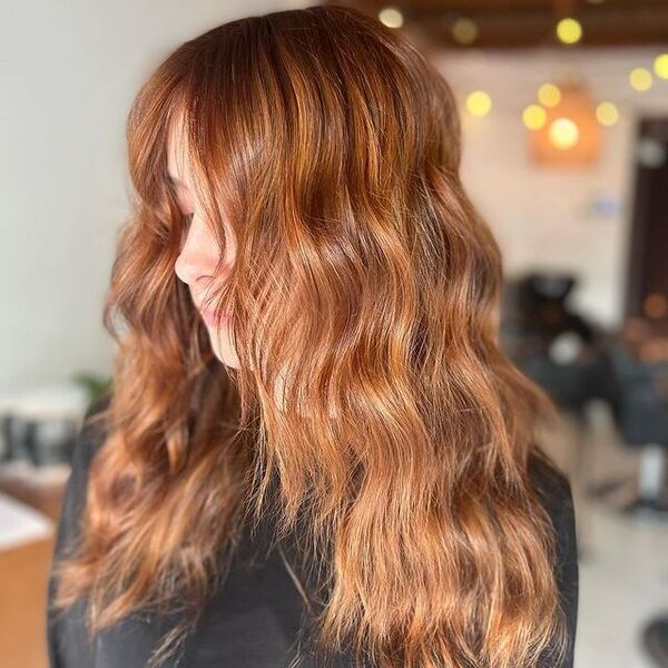 Strawberry Blonde Hair with Copper Tones - a woman wearing a black cape