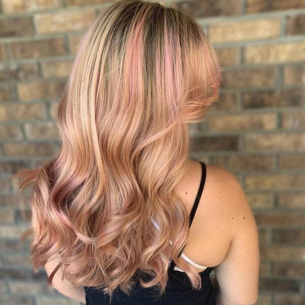 Strawberry Blonde Hair with Pink Highlights - a woman wearing a black sleeveless