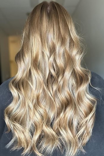 Warm Dimensional Blonde Waves on a woman with long blonde hair, back view.