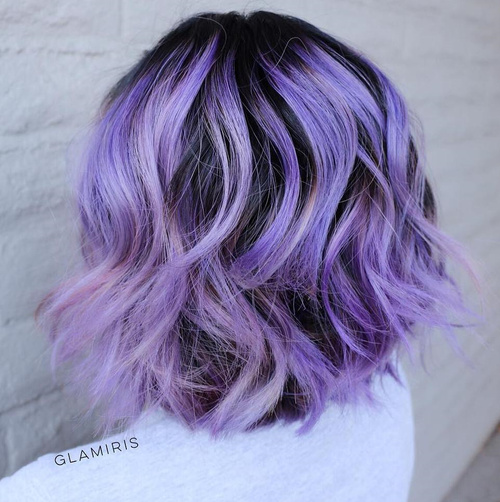 wavy pastel purple bob with black roots